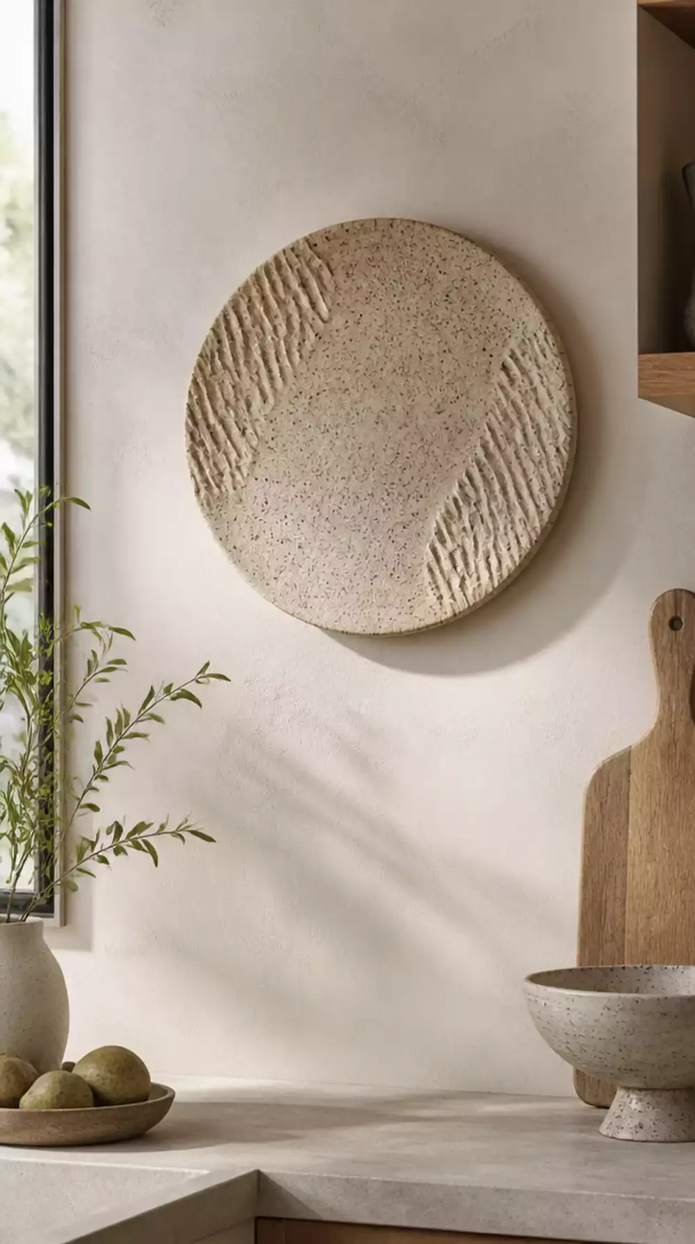 Kitchen Ceramic Wall Disc in a Speckled Clay Finish on a Bare Plaster Wall
